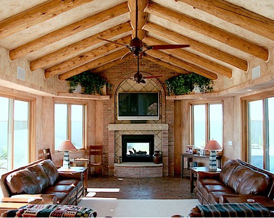 sunroom log beams leather couches