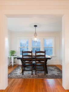 HighCraft-Builders-white-dining-room-remodel-with-clear-dining-room-pendant-light-and-refinished-floors