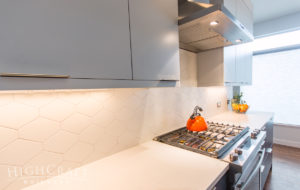 modern kitchen stainless appliances orange kettle on range
