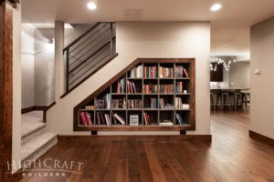 modern rustic basement understairs bookshelves