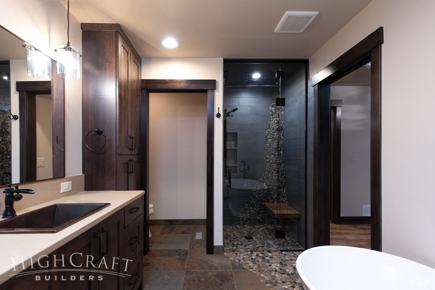 Modern-Rustic-Ranch-master-bath-shower-pebble-tile-waterfall