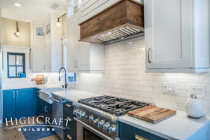 Open-concept-farmhouse-kitchen-blue-white-cabinets