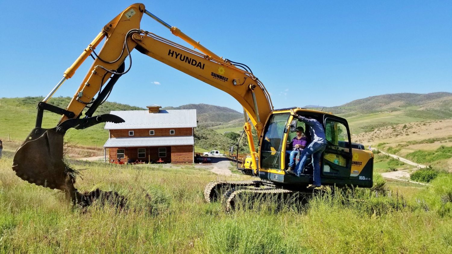 lesha breaks ground custom home contractor with trackhoe