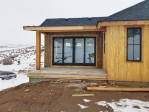 mountain_custom_home_building_exterior_concrete_master_bedroom_covered_porch