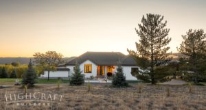 asian_inspired_whole_house_remodel_fort_collins_CO_exterior_front(white_stucco_black_tile_roof_sunset
