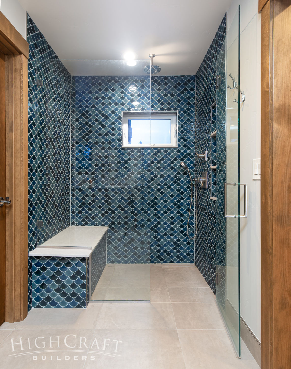 custom_house_builder_contractor_companies_master_bath_shower_bench_mermaid_tile_blue_glass_door