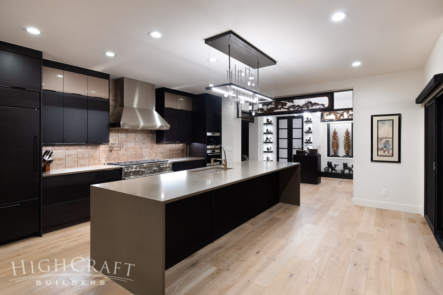kitchen_and_remodeling_quartz_countertop_waterfall_edge_island_slab_front_black_cabinetry