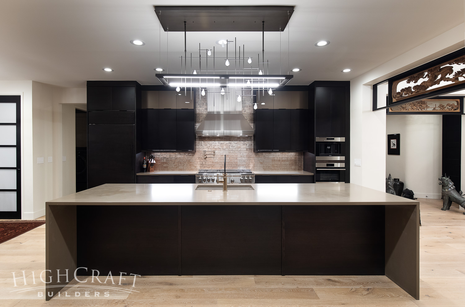 kitchen_and_remodeling_quartz_countertop_waterfall_edge_modern_black_cabinetry