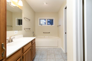 oak_vanity_bathtub_window_before_bathroom_remodel