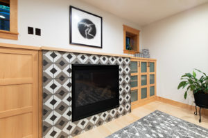 old-town-basement-remodel-geometric-tile-fireplace-built-ins