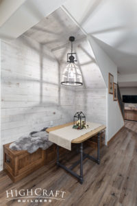 basement-remodeling-contractor-seating-nook-under-stairs-cage-pendant-light