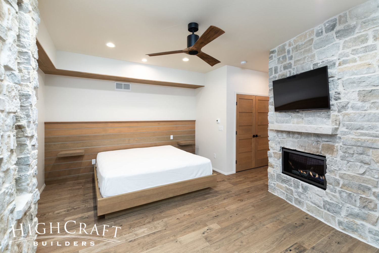 contemporary-custom-home-builder-guest-bedroom-wood-accent-wall-bed-platform