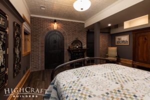 basement-finish-fort-collins-guest-bedroom-black-speakeasy-door-white-ceiling-tiles