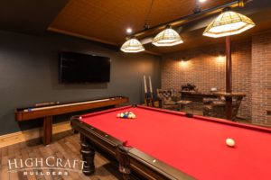 basement-finish-fort-collins-speakeasy-red-pool-table-shuffleboard-seating-tv