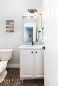 first-floor-remodel-bathroom-white-cabinet-blue-hex-tile-black-faucet