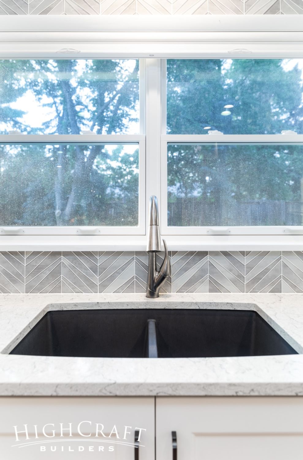 kitchen-remodel-dramatic-gray-chevron-tile-accent-wall-kitchen-sink