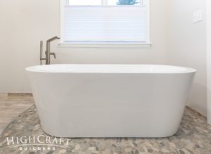 master-bathroom-remodel-white-freestanding-tub-pebble-tile