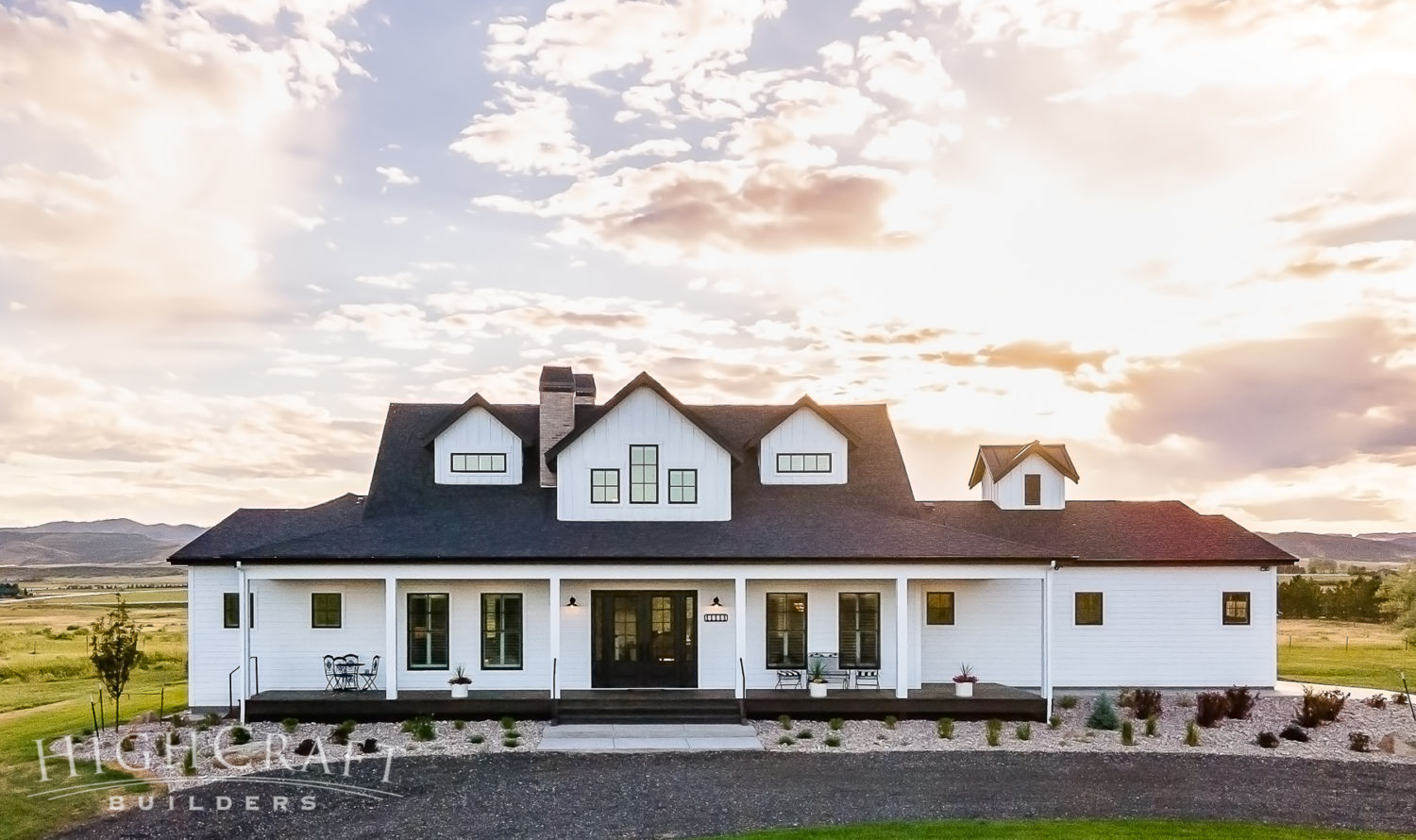 custom_home_builder_northern_co_white_farmhouse_front_amazing_sun