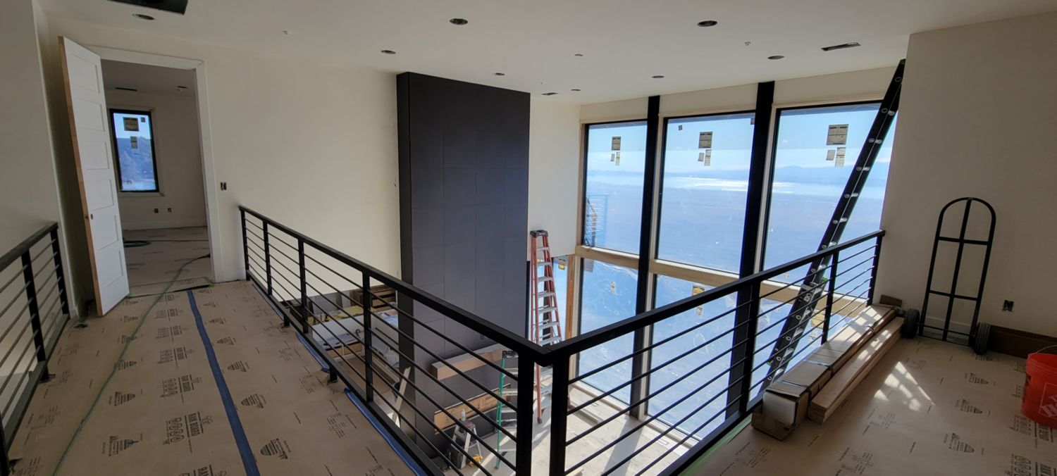 whole-house-remodel-black-metail-railings-installation-catwalk-fireplace
