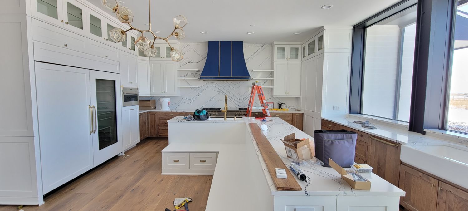 kitchen-remodel-navy-blue-gas-range-hood-white-cabinets-in-progress