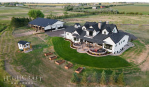 custom_home_builder_northern_co_white_farmhouse_aerial_view_west_side