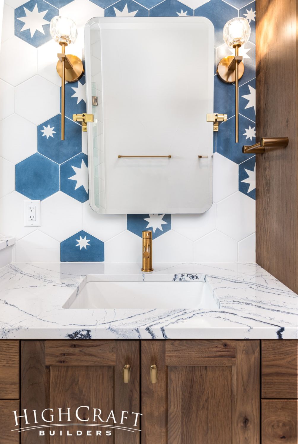 primary-bathroom-star-tiles-gold-fixtures-swivel-mirror