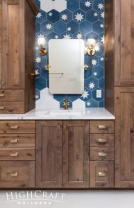primary-bathroom-star-tiles-gold-fixtures-wood-cabinetry