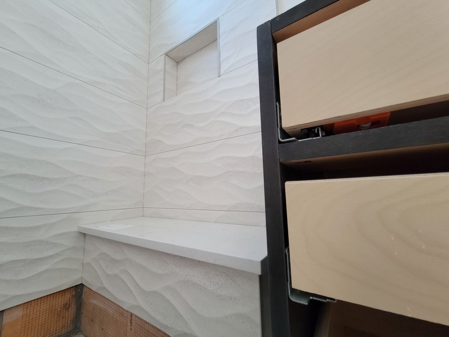 custom-home-builder-berthoud-bathroom-white-wave-tile-shower-progress