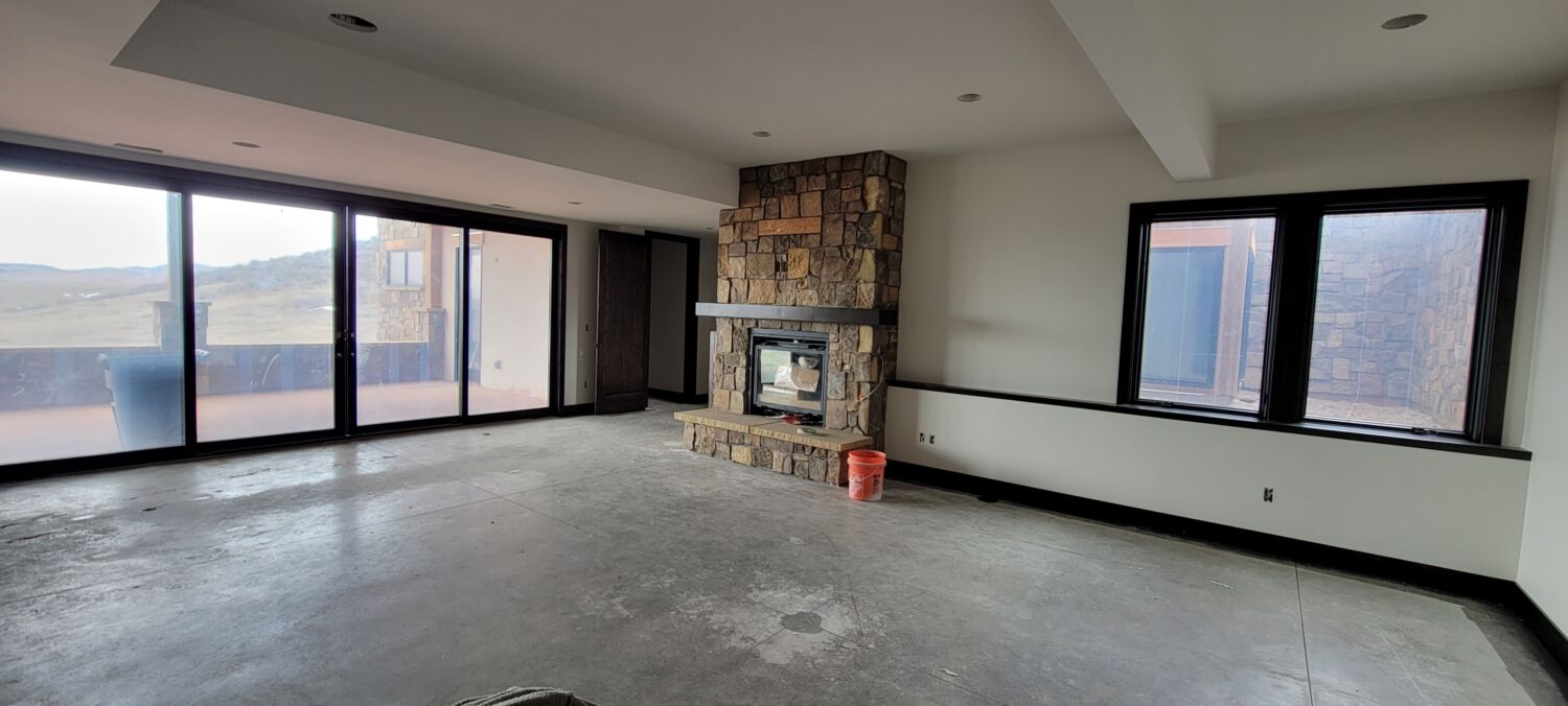 mountain-modern-custom-home-basement-fireplace-stone-progress