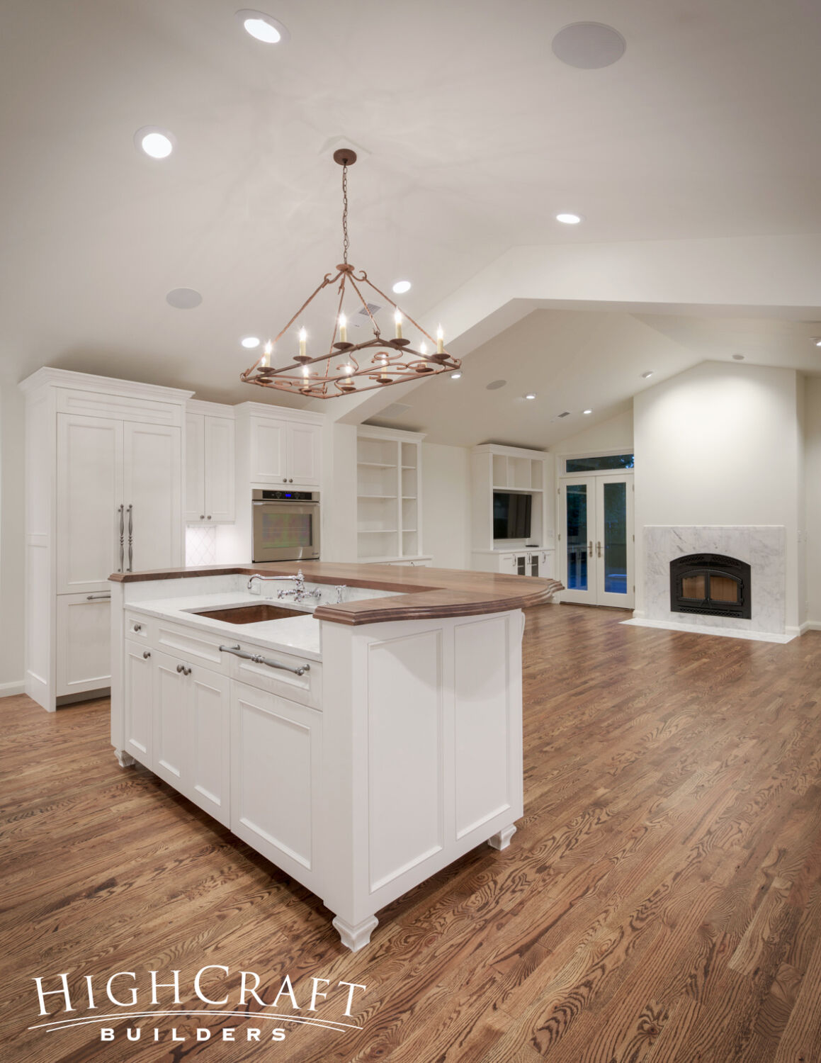 Kitchen-And-Great-Room-Addition-Furniture-Leg-White-Cabinet-Island-Chandelier-Wood-Countertop-Quartz-Oak-Flooring-Fireplace-Vaulted-Ceiling