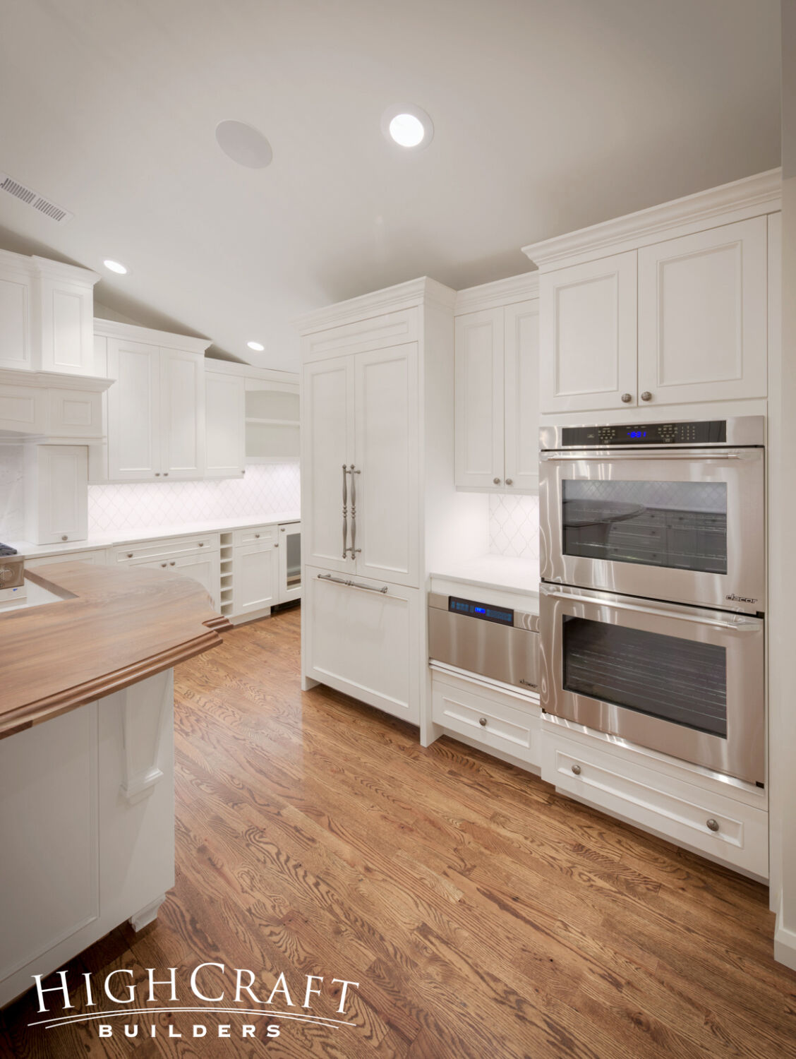 Kitchen-And-Great-Room-Addition-White-Cabinets-Paneled-Fridge-Appliances-Double-Oven-Oak-Floors