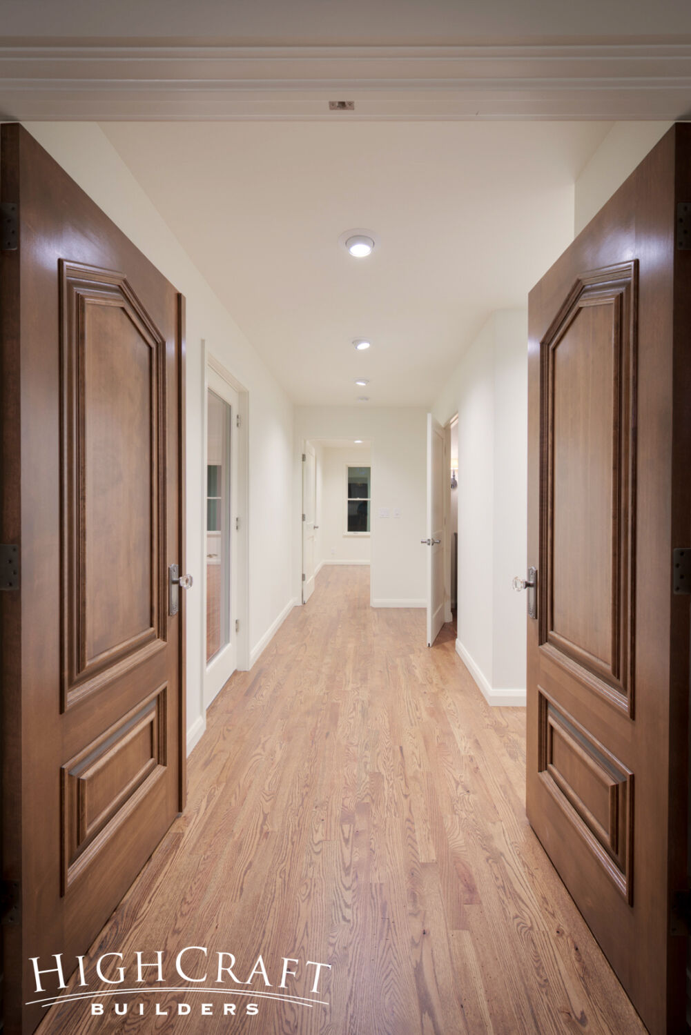 Kitchen-And-Great-Room-Addition-White-Walls-Hardwood-Floor-Hallway-Two-Panel-Doors