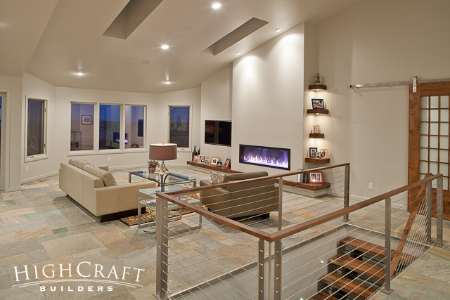 Modern-Mountain-Open-Concept-Living-Room-Slate-Flooring-Fireplace-Accent-Lighting-Cable-Railing-Barn-Door