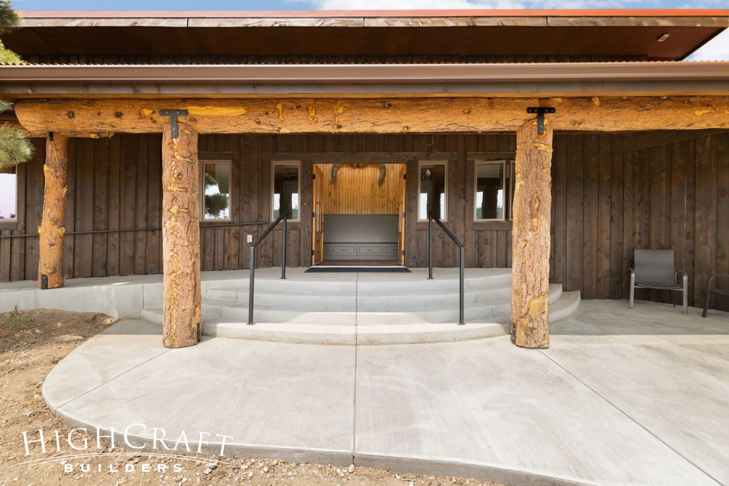 Master-Suite-Addition-Rustic-Front-Entry-Curved-Patio-Steps-Timber-Pillars