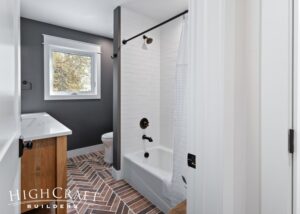 bathroom-remodel-brick-tile-flooring-bathtub-shower