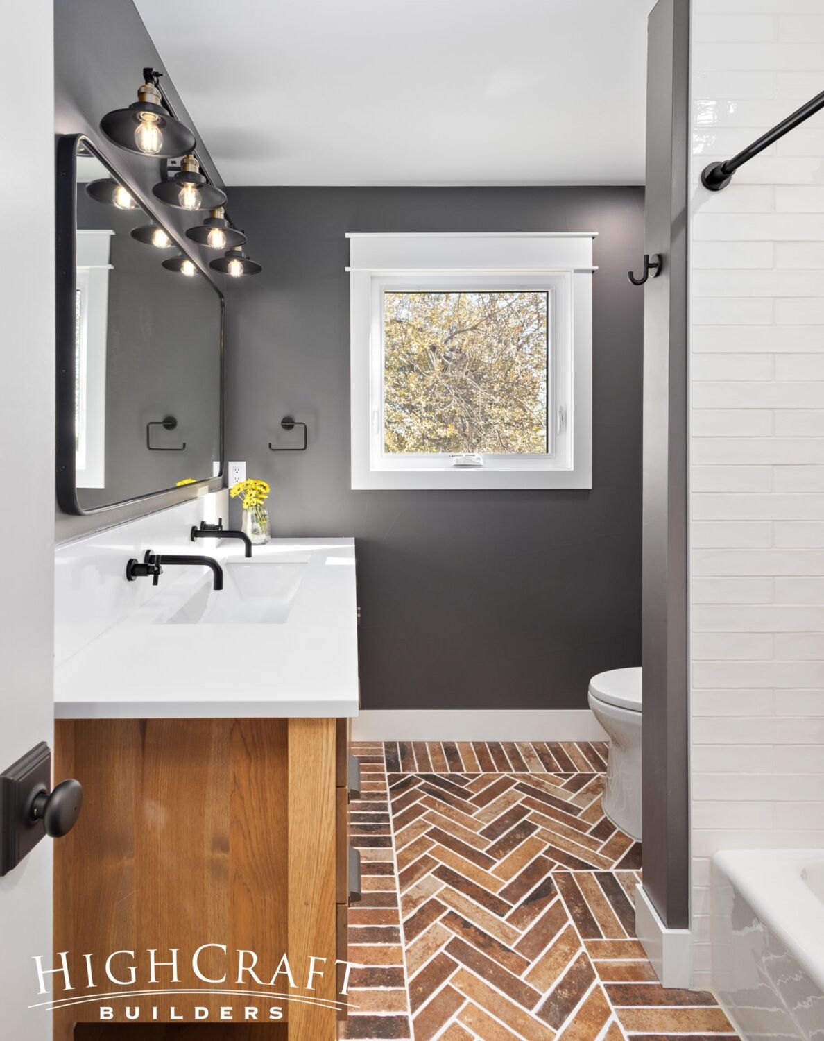 bathroom-remodel-brick-tile-flooring-bathtub-shower-vanity