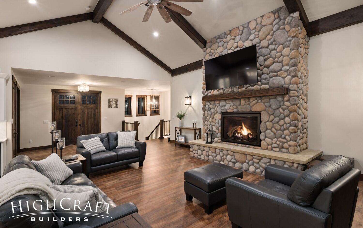 custom-home-near-me-great-room-river-rock-fireplace-vaulted-ceiling