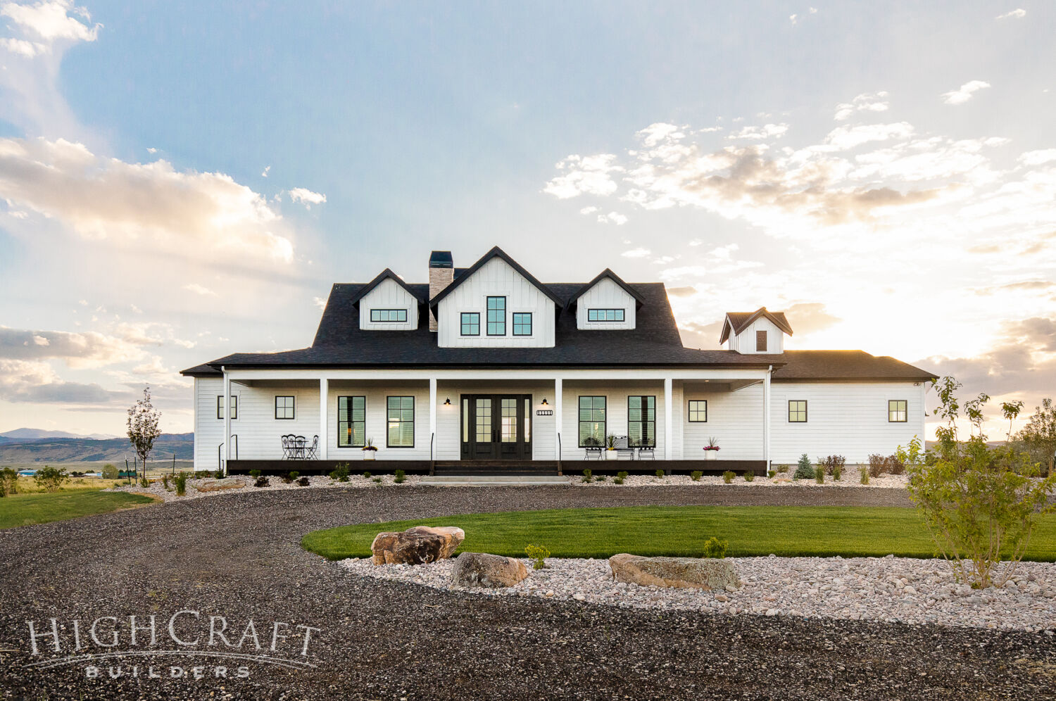 custom_home_builder_fort_collins_co_white_farmhouse_front_sunset